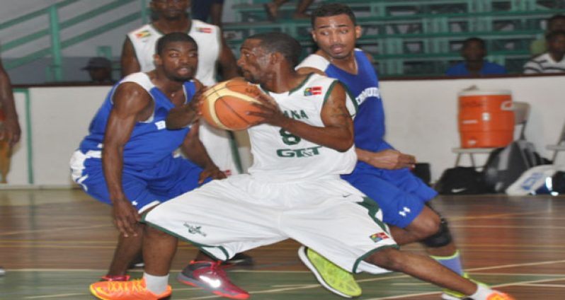 Guyana’s Travis Burnett on his way to scoring two of his 17 points, against Bermuda, at the Cliff Anderson Sports Hall. (Delano Williams photos)