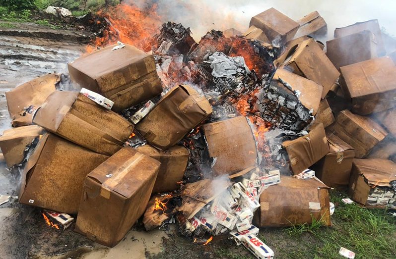 The seized cigarettes being destroyed