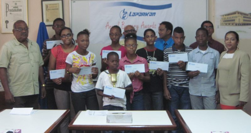 In picture, new and previous awardees pose with the Consultant of Wm. Fogarty Ltd. Mr. Oscar Phillips and CFO/Corporate Secretary, Mr. Sahadeo Ramkirath (back row with blue shirt) and other Executives of the Laparkan Group