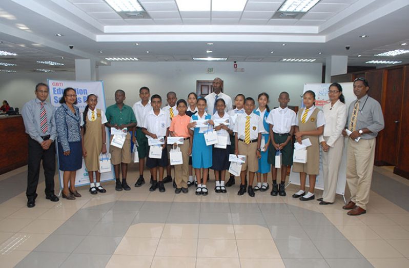 Senior Education Officer (Mathematics) Ameer Ali and  senior managers of GBTI with this year’s bursary awardees (GBTI photo)