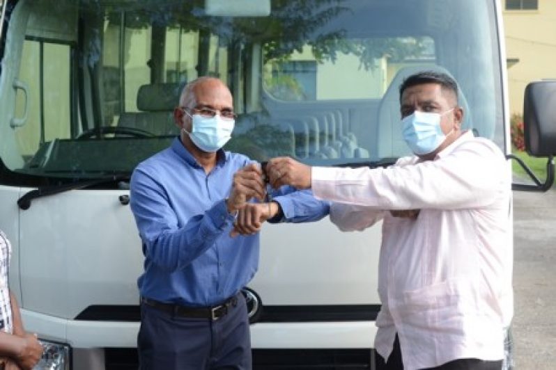 Agriculture Minister, Zulfikar Mustapha, handing over the keys to the bus to Chief Executive Officer of GSA, Brian Greenidge