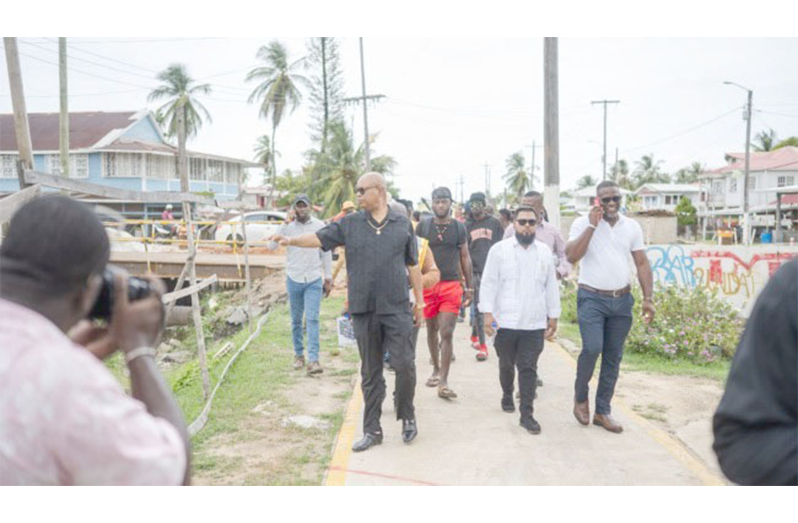 Minister of Public Works Bishop Juan Edghill with residents and vendors of the Buxton community (DPI photos)