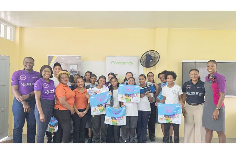 Caribbean Airlines and GTA teams with students and a teacher at one of the schools at which they conducted the programme (Photo: Guyana Tourism Authority/ Facebook)