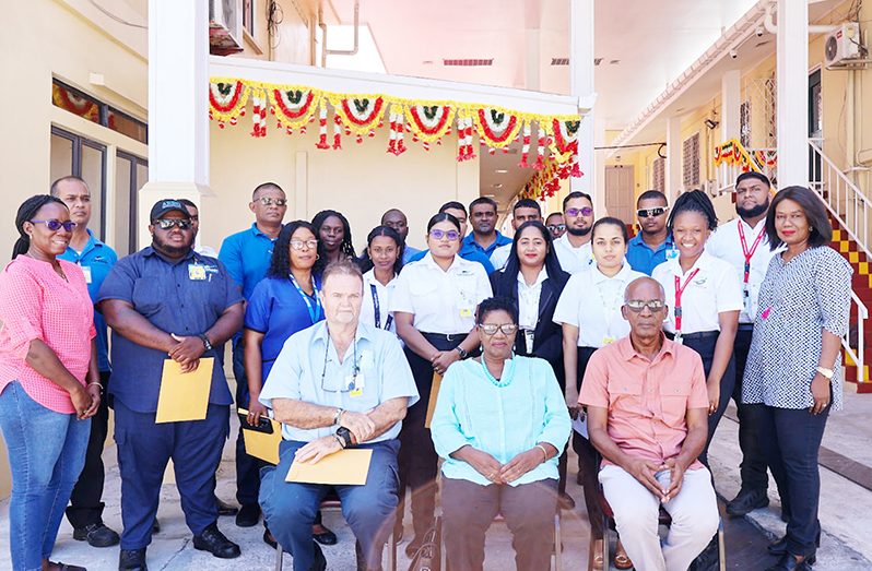 Joseph Hamilton, Minister of Labour (seated at right) with other officials and the CAMS employees on the Joint Workplace Safety and Health Committee that completed the training programme