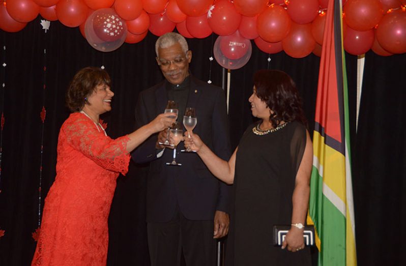 President David Granger, Canadian High Commissioner to Guyana, Lilian Chatterjee (left) and Minister of State, Dawn Hastings-Williams share a toast to fruitful years of bilateral relations. (Adrian Narine photo)