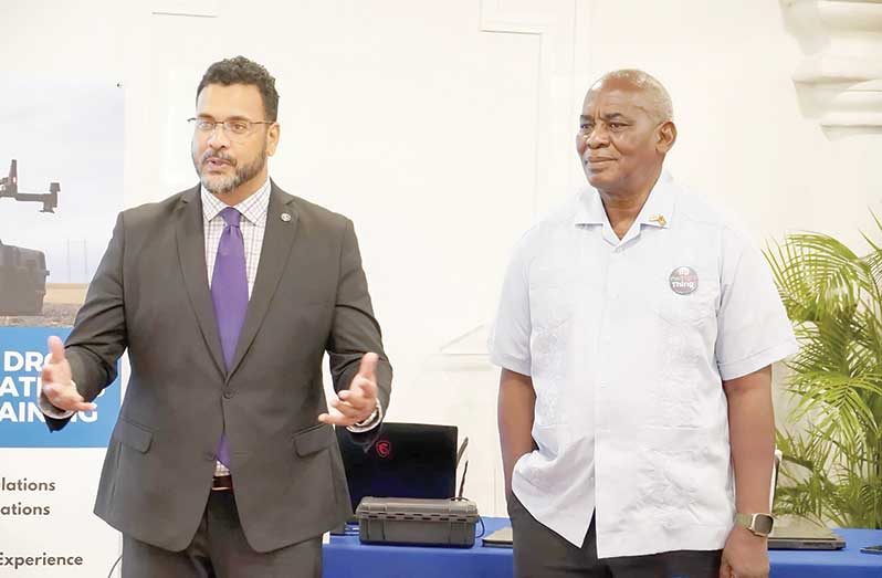 Minister of Home Affairs, Robeson Benn, with Director of CANU, James Singh, giving remarks during the drone training programme