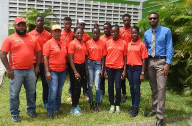 Director of Sport Christopher Jones (right), with the Guyana CARIFTA team just before they left for Curacao.