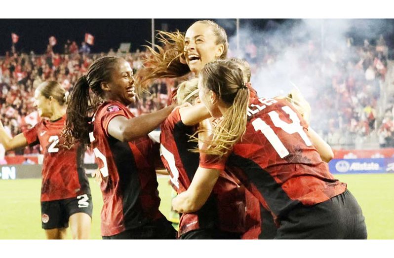 Canada's players celebrate a goal against Jamaica at BMO Field in Toronto, on Tuesday