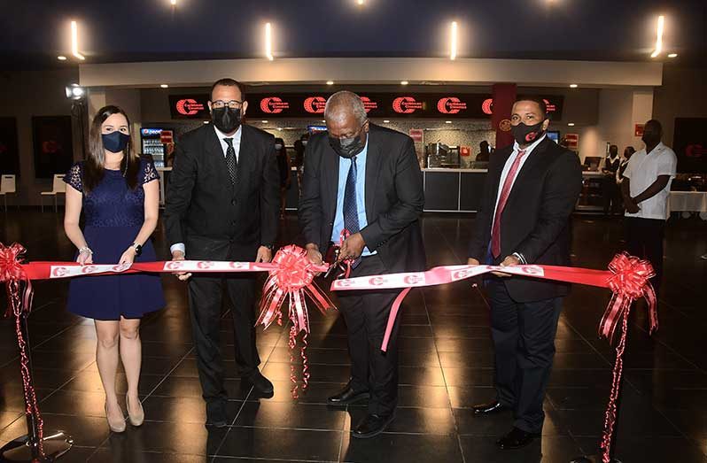 Prime Minister, Brigadier (ret’d) Mark Phillips and Caribbean Cinemas’ Director of operations, George Borges, at the ceremonial ribbon cutting to officially open the cinema at Amazonia Mall (Adrian Narine photo)