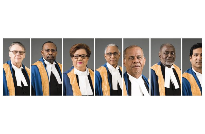 (L-R) Justice Jacob Wit, Justice Winston Anderson, President of the CCJ Justice Adrian Saunders, Justice Maureen Rajnauth-Lee, Justice Denys Barrow, Justice Andrew Burgess and Justice Peter Jamadar.