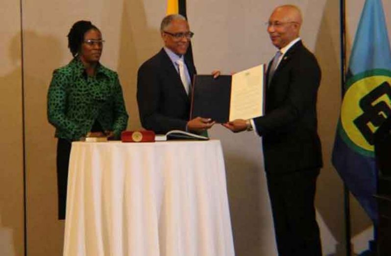 Newly appointed President of the CCJ, Justice Adrian Saunders and Governor-General of Jamaica, Sir Patrick Allen, after the swearing in