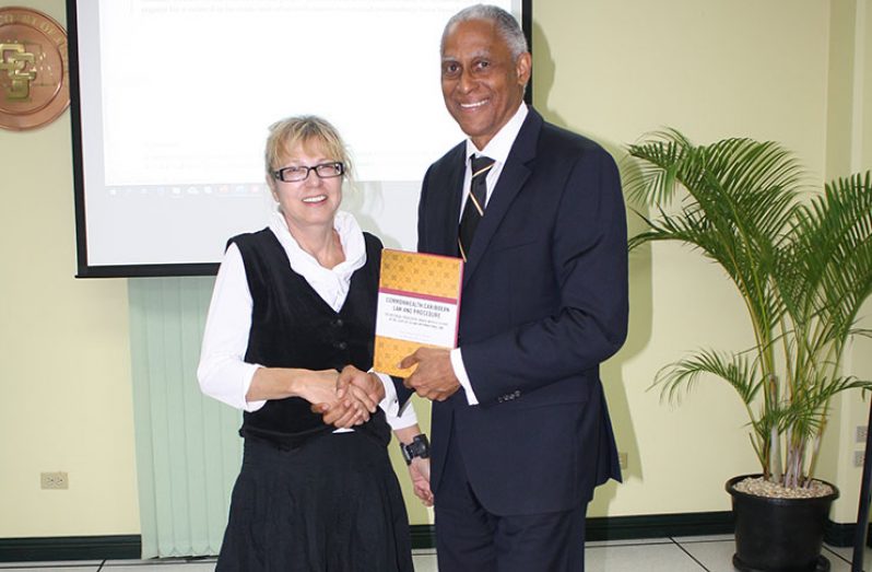 Prof. Kaczorowska-Ireland makes a presentation to Court President, Hon. Mr. Justice Saunders