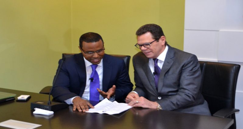 President of the Caribbean Development Bank (CDB), Dr William Smith chats with Director of Economics at the CDB, Dr Justin Ram, following the bank’s press conference yesterday in Barbados