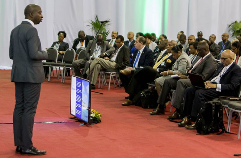 Dr Amos Peters (standing), economist, CDB, addresses the audience during the seminar