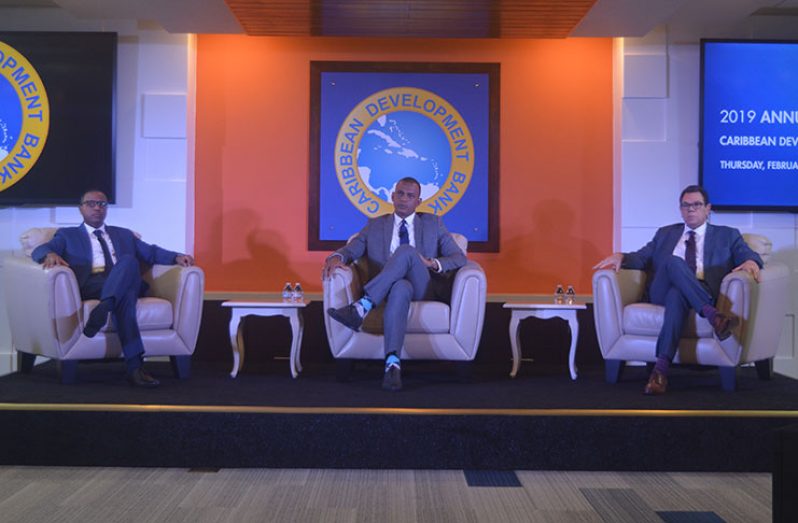Seated [from left] at the Caribbean Development Bank’s Annual News Conference on Thursday in Barbados are Director of Economics, Dr Justin Ram; Director of Projects, Mr Daniel Best and CDB President, Dr William Warren Smith