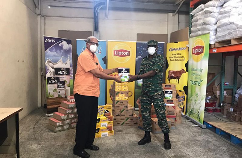 CEO of DeSinco Trading Limited, Frank DeAbreu, hands over the supplies to Director-General of Civil Defence Commission (CDC), Lieutenant Colonel Kester Craig