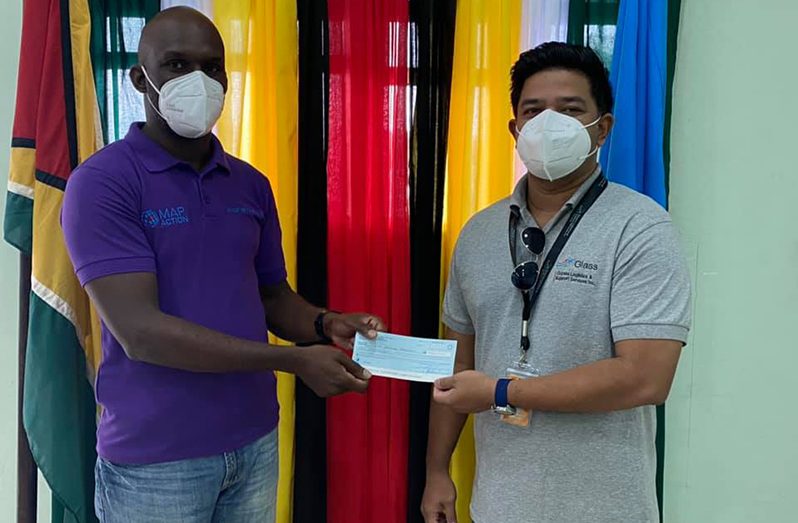 The Civil Defence Commission (CDC) receiving the $10M donation from Corporate Secretary of Mid Atlantic Oil and Gas Inc, Glenn Low-A-Chee (CDC photo)