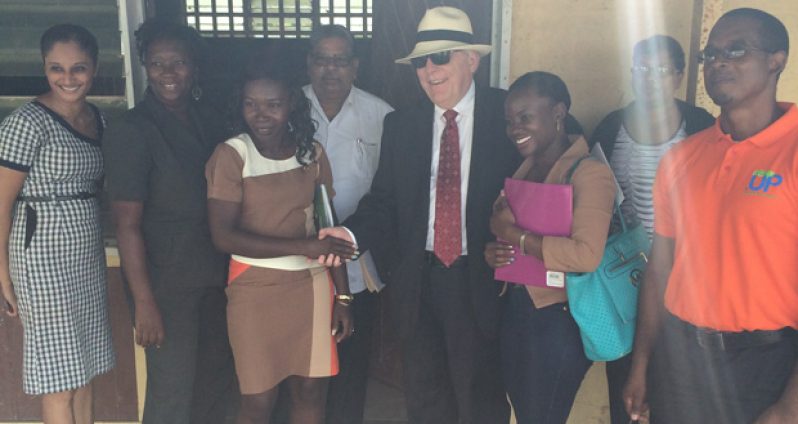 High Commissioner Giroux poses with the Fort Ordnance Primary School Head Teacher; CDC Director General, Colonel Chabilall Ramsarup (ret'd), and parents of some of the students