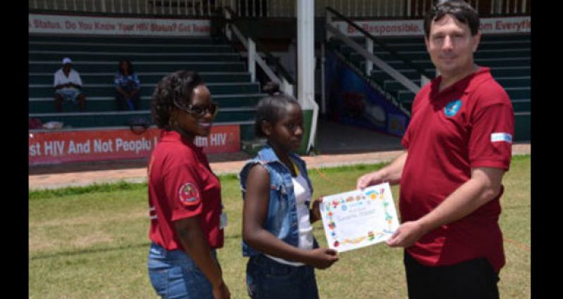 One of the children receives her certificate of participation