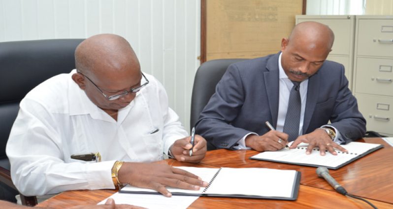 Finance Minister Winston Jordan and CARICOM Development Fund (CDF) CEO Rodinald Soomer signing the agreement yesterday
