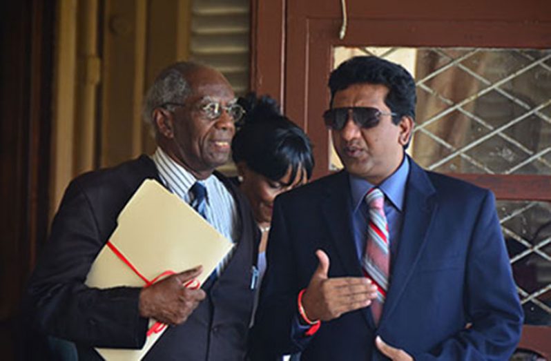 Former Attorney-General, Anil Nandlall and Senior Counsel, Ashton Chase, in discussion, shortly after the hearing in the Chief Justice Chambers with regards to the 2014 court matter