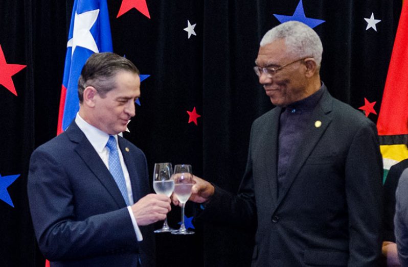 President David Granger and Chilean Ambassador to Guyana, Patricio Becker share a toast (Delano Williams photo)