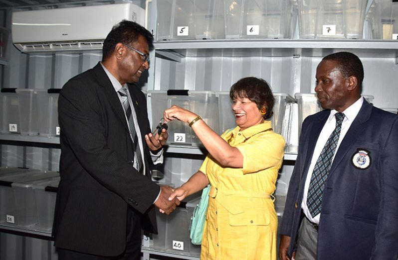 Public Security Minister, Khemraj Ramjattan receives the key to the facility from Canadian High Commissioner, Lilian Chatterjee in the presence of acting Crime Chief Paul Williams