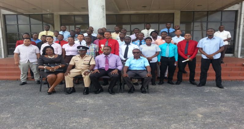 The 37 ranks to be added to the CID pose with one of the facilitators, Attorney-at-Law, Joann Edghill; Force Training Officer, Paul Williams; Deputy Crime Chief, Wendell Blanhum; and senior officer, De Hearte at the conclusion of the closing ceremony Thursday (Photo by Michel Outridge)