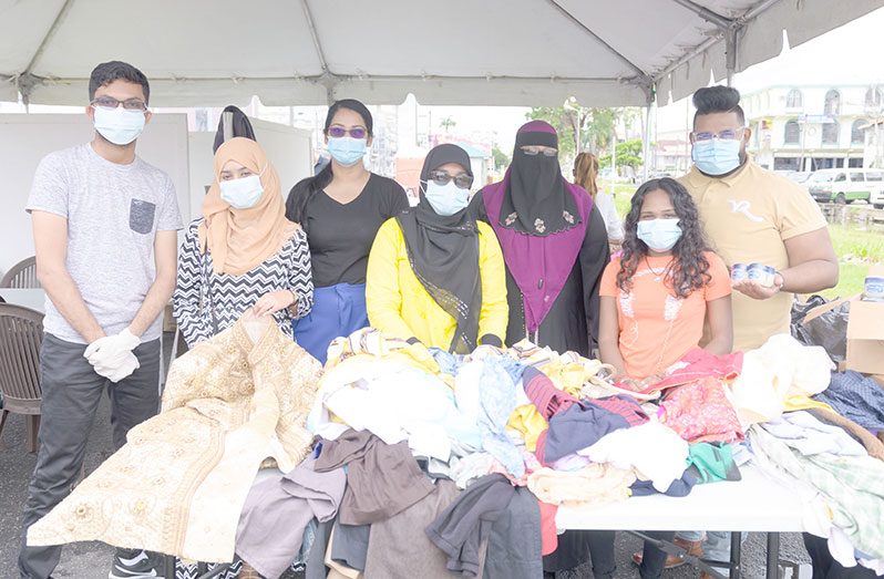 Representatives of the CIOG with some items of clothing  that were distributed to the homeless