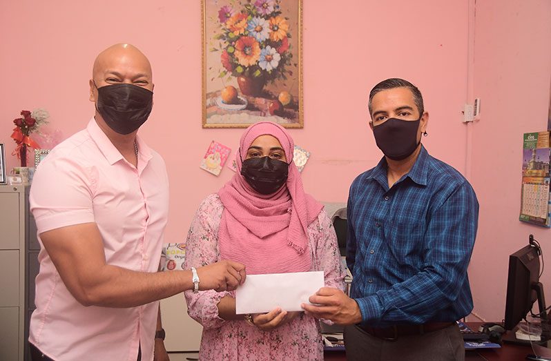 Businessman Ferez khan (left) hands over the cheque to CIOG General Manager Shameena Haniff and leader of the Military Information Support Team of the United States Embassy, David Giraldo (Adrian Narine photo)