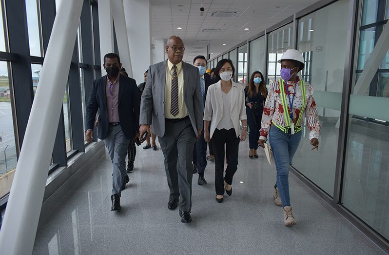Public Works Minister Juan Edghill (second from left) along with Chinese Ambassador to Guyana, Guo Haiyan (second from right); CJIA’s Chief Executive Officer, Ramesh Ghir and Project Manager of the CJIA Expansion Project, Carissa Gooding, inspect the 305-metre-long boarding corridor, on Thursday (Elvin Croker photo)