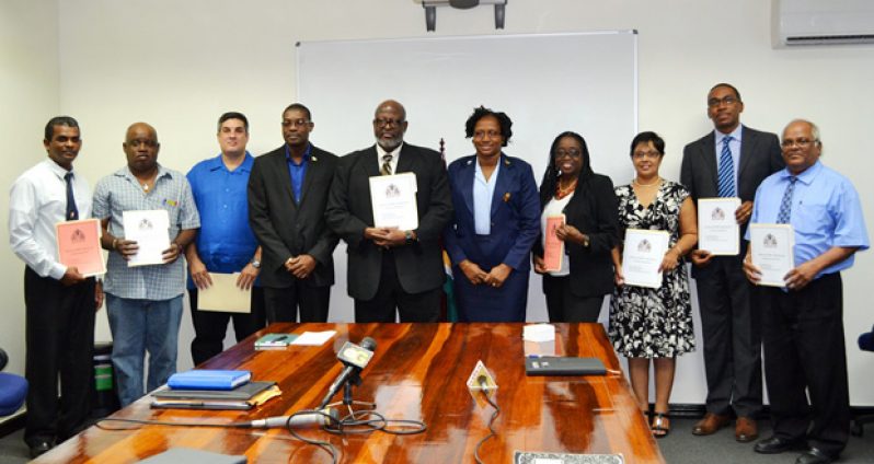 Minister of Public Infrastructure , David Patterson and Junior Minister within that ministry , Annette Ferguson , pose with newly appointed members of the CJIA board.