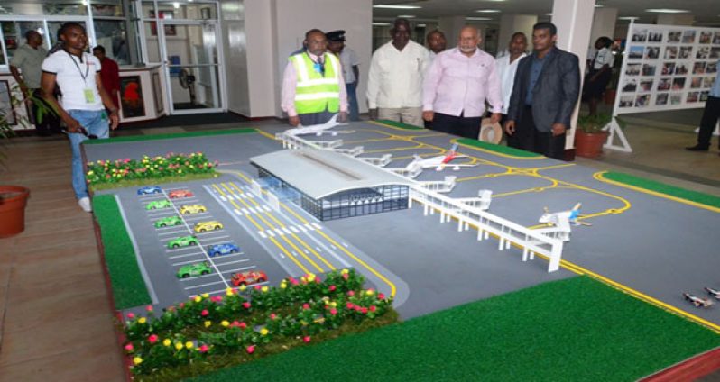 ‘FLASHBACK’: A replica of the Cheddi Jagan International Airport expansion project on display, in March last year, as President Donald Ramotar visits the arrival lounge in the company of Minister of Public Works, Robeson Benn and Chief Executive Officer of the airport, Ramesh Ghir