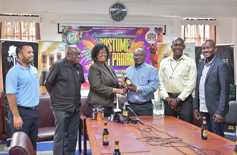 Acting Administrator for the Unit of Allied Arts, Lorraine Barker-King, solidifies the donation by means of a handshake with Communications Manager of Banks DIH Ltd, Troy Peters. 
Included in the photograph are: (from left) Head of the Physical Education Department at the Unit of Allied Arts, Nicholas Fraser; Chief Education Officer, Marcel Hutson; Non-alcoholic Malts Brand Manager at Banks DIH, Clayton McKenzie and Public Relations Officer of the Ministry of Education, Mondale Smith (Photo by Samuel Maughn)