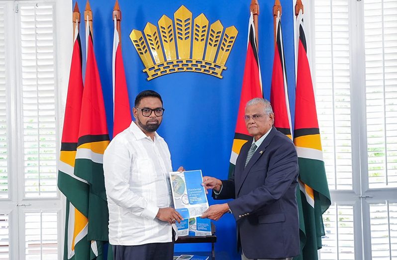 CoI Chairman former Chief of Staff of the Guyana Defence Force (GDF), Major-General Joe Singh handing over the findings of the report to President Dr. Irfaan Ali