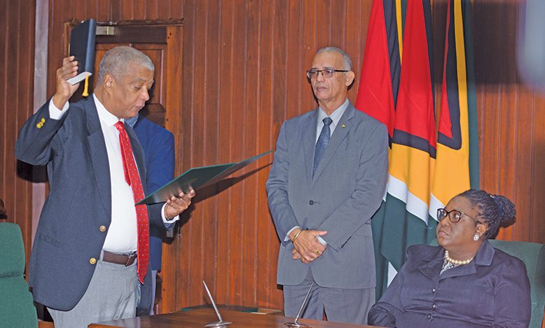 Chair of the elections inquiry, retired Justice of Appeal, Stanley John, being sworn in by Chief Magistrate Ann McLennan on Tuesday (Delano Williams photo)