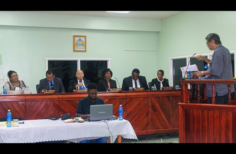 Members of the Commission of Inquiry listen as IAC executive member, Evan Persaud, provided testimony on Tuesday