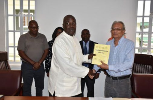 Education CoI Chairman Ed Caesar handing over the preliminary report to Education Minister Dr Rupert Roopnaraine on Friday