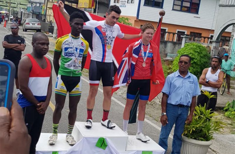 Trinidad & Tobago’s Enrique Comarmond (centre) is flanked by second placed Kianny Noel of St Martin (left) and third placed Nicholas Narraway (Bermuda) on the podium.