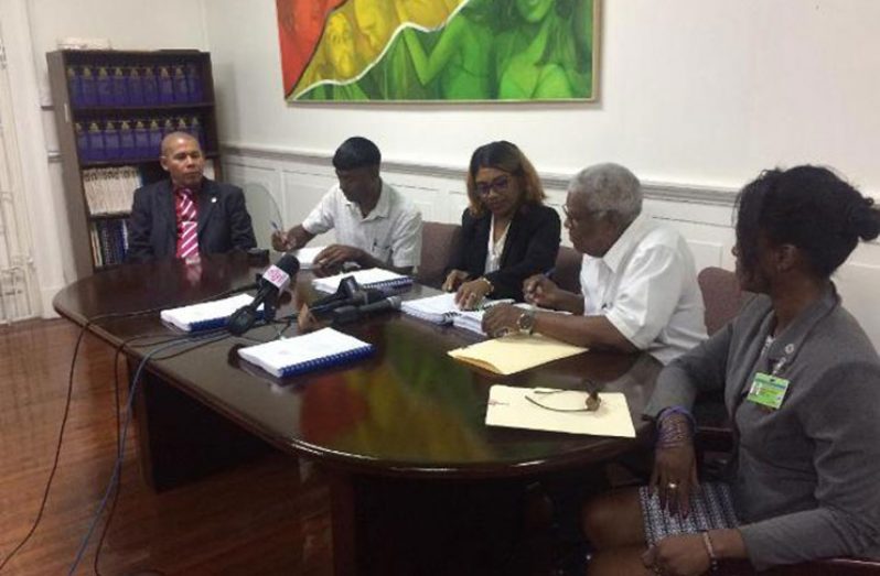 Contracts are signed in the presence of Minister of Social Cohesion Dr George Norton (far left) and Assistant Director of Sport, Melissa Dow-Richardson (far right), by Chief Executive Officer of Builders Hardware and Supplies, Rakesh Samaroo. (DPI photo)