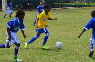 Part of the action between St Margaret’s Primary and Tucville Primary yesterday in the COURTS Pee Wee football tournament (Adrian Narine photo)