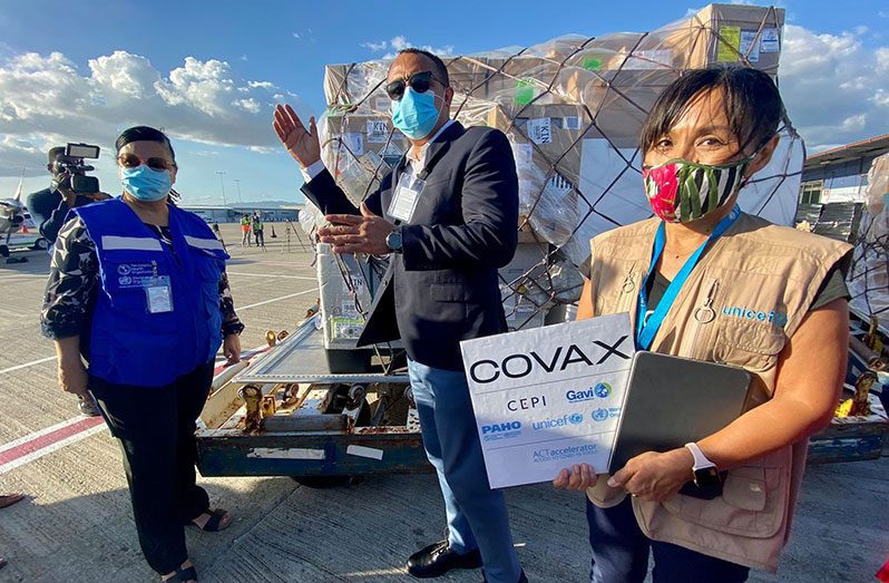 Minister of Health and Wellness in Jamaica, Dr. Christopher Tufton (centre) receives the 14,400 doses of the COVID-19 vaccine, which Jamaica procured under the COVAX Facility (Jamaica Observer photo)
