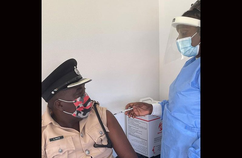 Commander Errol Watts receiving his vaccine