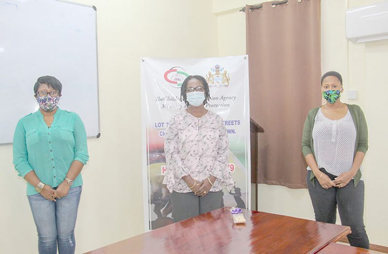 Assistant Director, Ms. T. October, University of Guyana Lecturer, Debbie Hopkinson, centre alongside Manager of Care Centers, Ms. M. Gentle during the presentation of the flash drives.