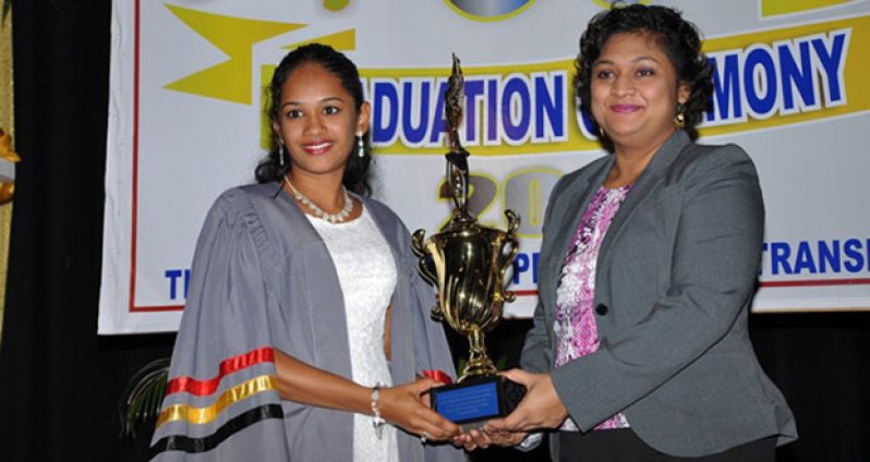 Education Minister Priya Manickchand presenting Duviena Badray, the best graduating student, with a trophy. Badray was also presented with two other awards