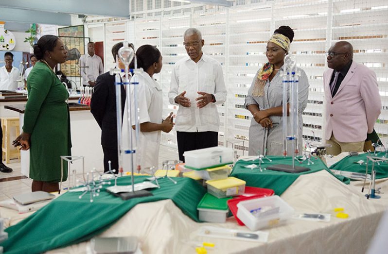 President David Granger in discussion with Science Lecturer, Reshana LaRose, on the benefits of the science equipment. Observing are CPCE Principal, Viola Rowe; Ambassador Cui Jianchun; Minister of Education, Dr. Nicolette Henry, and Chief Education Officer, Marcel Hutson.