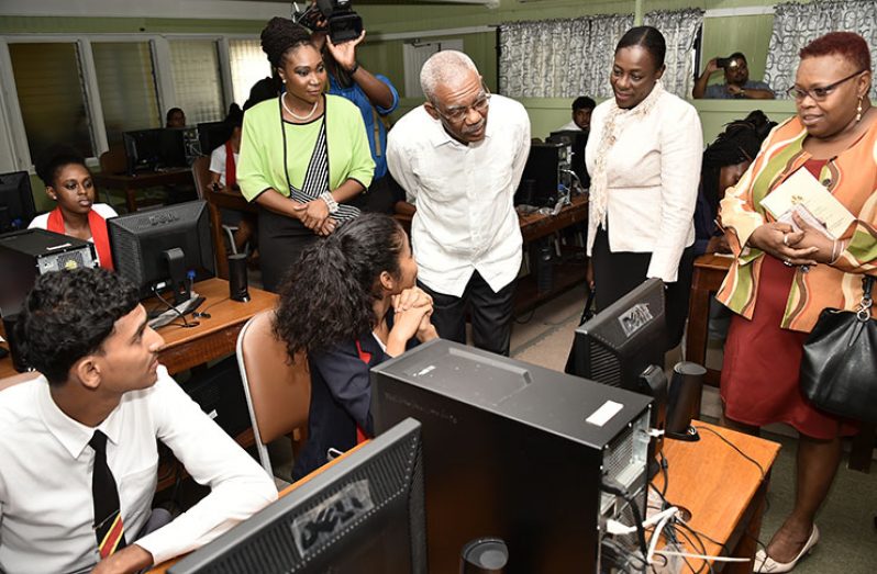President David Granger takes a glimpse at the online research that students in the Information Technology laboratory are conducting. Also in photo are: Minister of Education, Nicolette Henry and CPCE Principal, Ms. Viola Rowe (MoTP photo)