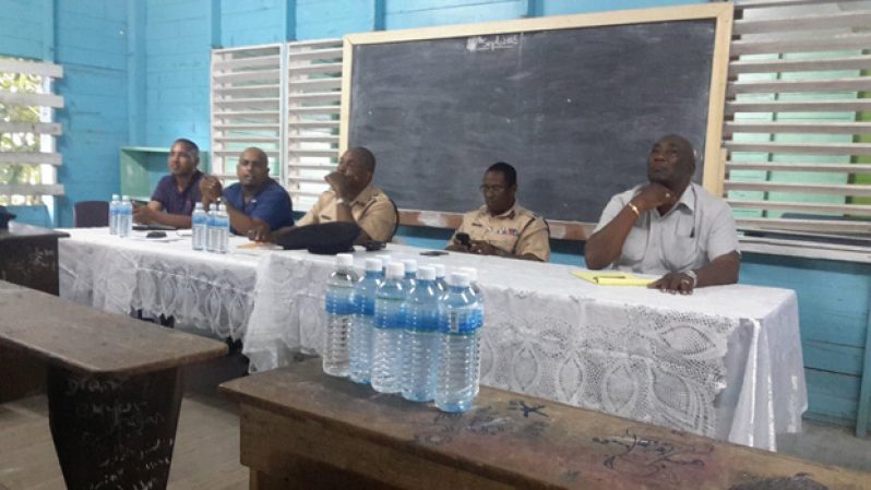 Commander Hicken, Public Security representative Pompey and Deputy Commander Ian Amsterdam along with two executives of the East Bank Demerara CPGs share the head table