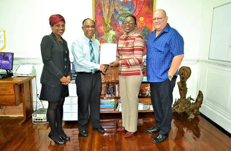 Minister Nicolette Henry (second from left) and Guyana Amazon Warriors Omar Khan hold the agreement signed yesterday for the use of the Guyana National Stadium. Also in photo are Permanent Secretary Melissa Tucker and Anthony Xavier.