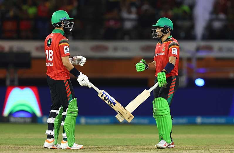 :  Moeen Ali (L) and Rahmanullah Gurbaz (R) of Guyana Amazon Warriors build a partnership during the Men's 2024 Republic Bank Caribbean Premier League semi final match between Barbados Royals and Guyana Amazon Warriors at the Providence Stadium on October 04, 2024 in  Guyana. (Photo by Ashley Allen - CPL T20/CPL T20 via Getty Images